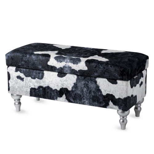 Un puf con compartimento de almacenamiento tapizado con estampado de vaca, cómodo y decorativo para el interior