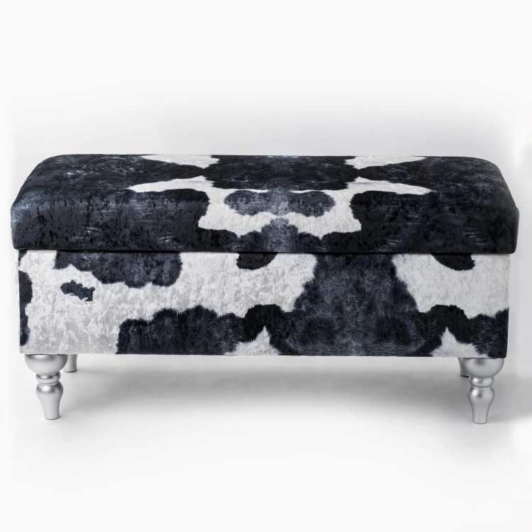 Puf de almacenaje con tapizado con estampado de vaca