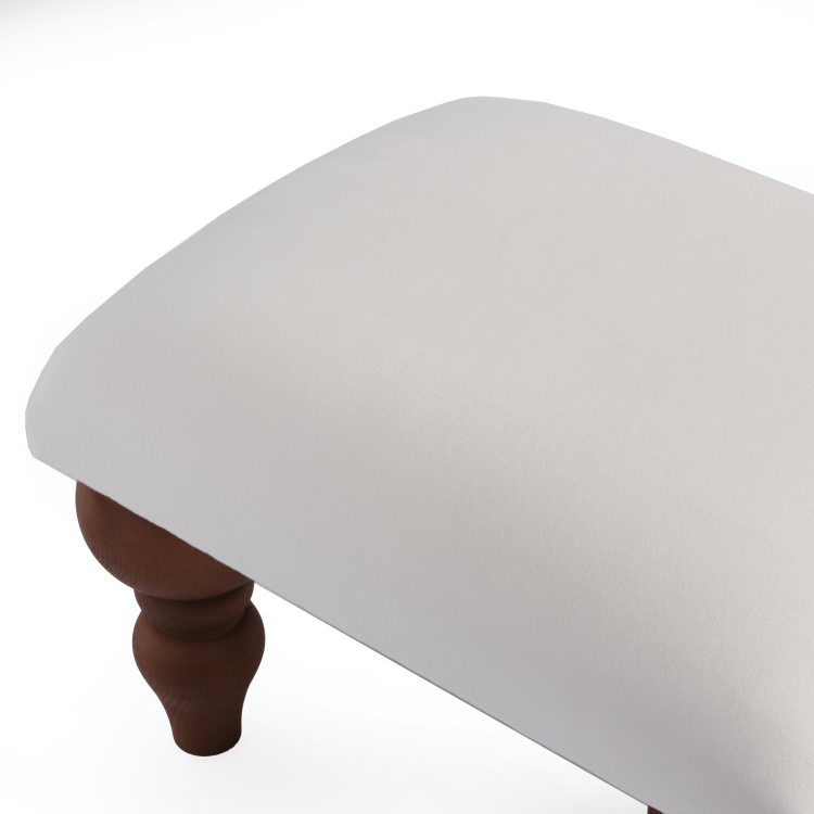 Un cómodo reposapiés blanco, un elegante complemento para el sillón de la sala de estar