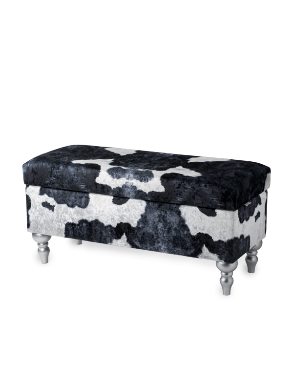 Un puf con compartimento de almacenamiento tapizado con estampado de vaca, cómodo y decorativo para el interior
