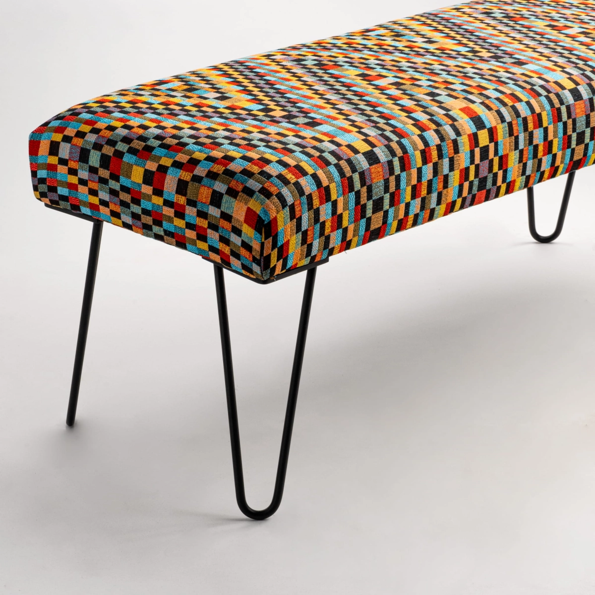 Banco tipo loft estampado con tapizado decorativo y finas patas de metal